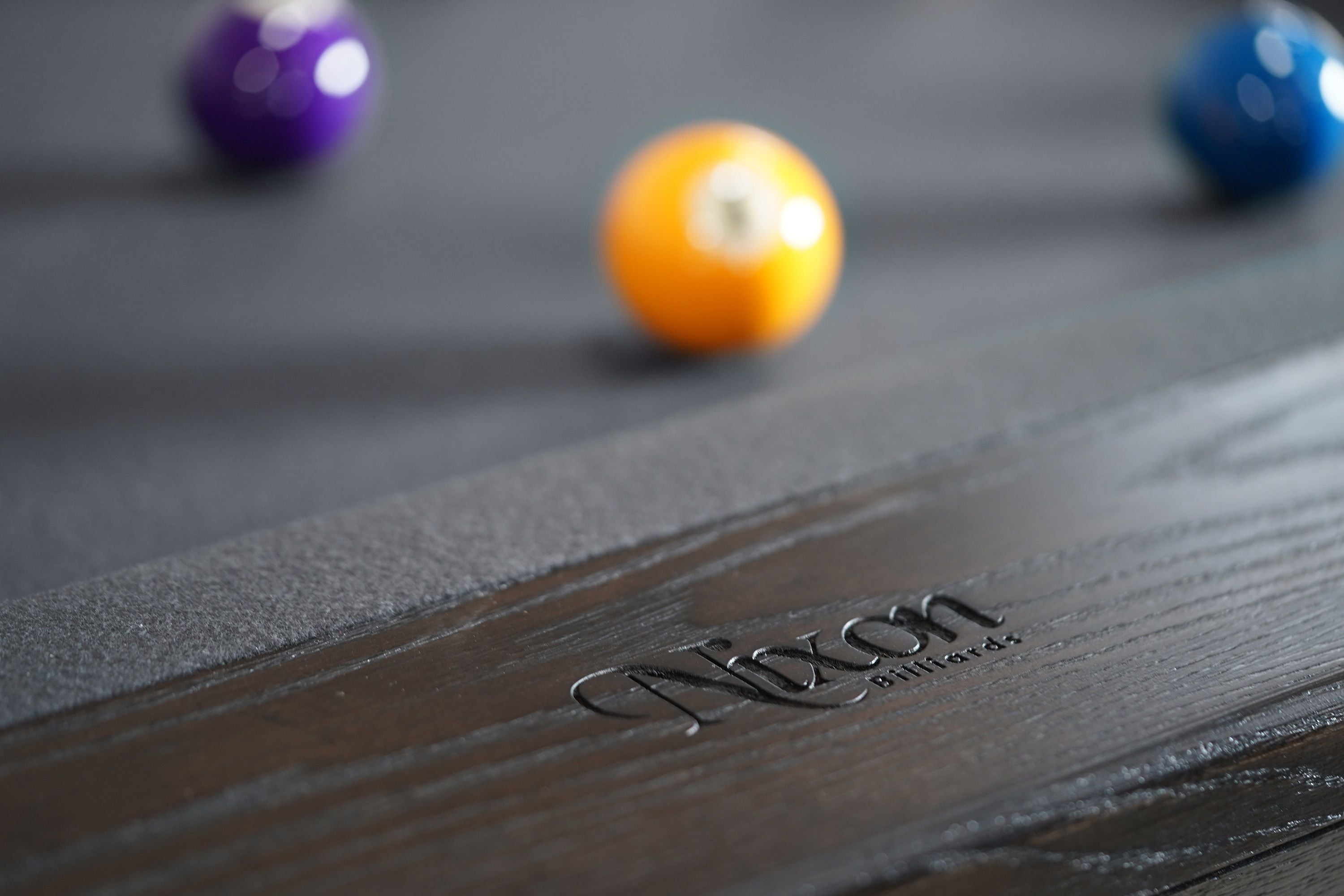 Nixon KAI 7' Slate Pool Table by Nixon Billiards in Waxed Brown, shown with billiard balls.