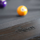 Nixon KAI 7' Slate Pool Table by Nixon Billiards in Waxed Brown, shown with billiard balls.