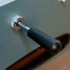 Close-up of René Pierre Color Menthe Foosball Table's black handle and telescopic rods.