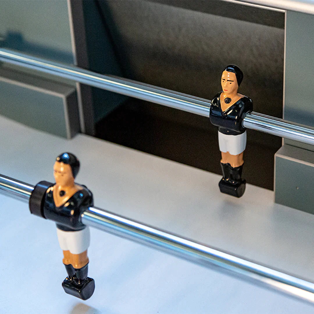 Two foosball figures on telescopic rods of the René Pierre Color Menthe Indoor Foosball Table.