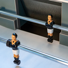Two foosball figures on telescopic rods of the René Pierre Color Menthe Indoor Foosball Table.