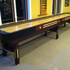 Champion 9' The Grand Champion Shuffleboard Table in a carpeted, yellow-walled room.
