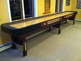 Champion 9' The Grand Champion Shuffleboard Table in a carpeted, yellow-walled room.