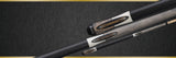Close-up of three Lucasi Lux® LUX66 Pool Cues with inlays on a dark background.