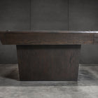 A Nixon KAI 7' Slate Pool Table in waxed brown sits beside a modern dark wood shuffleboard table.