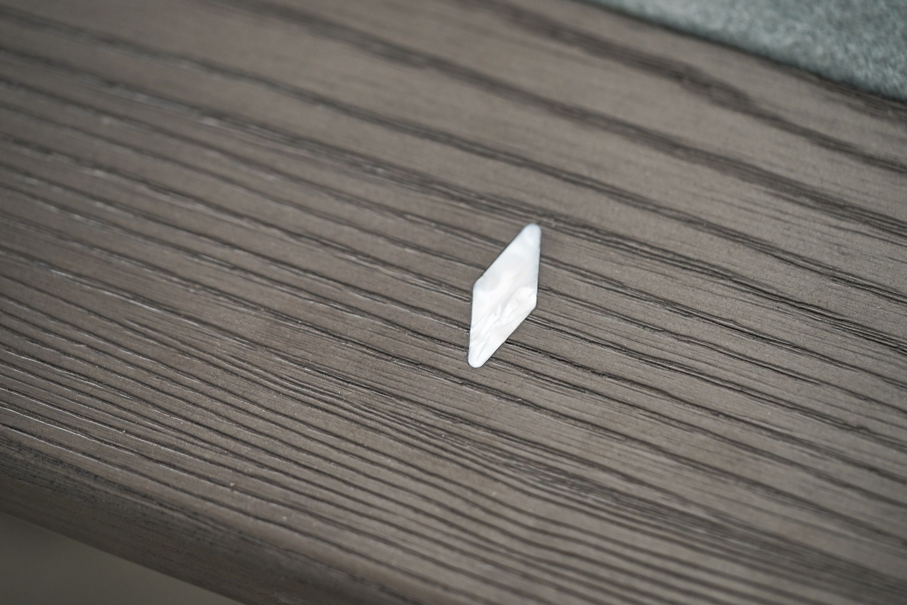 A small plastic triangle on the Nixon Birdy 7' Slate Pool Table by Nixon Billiards.