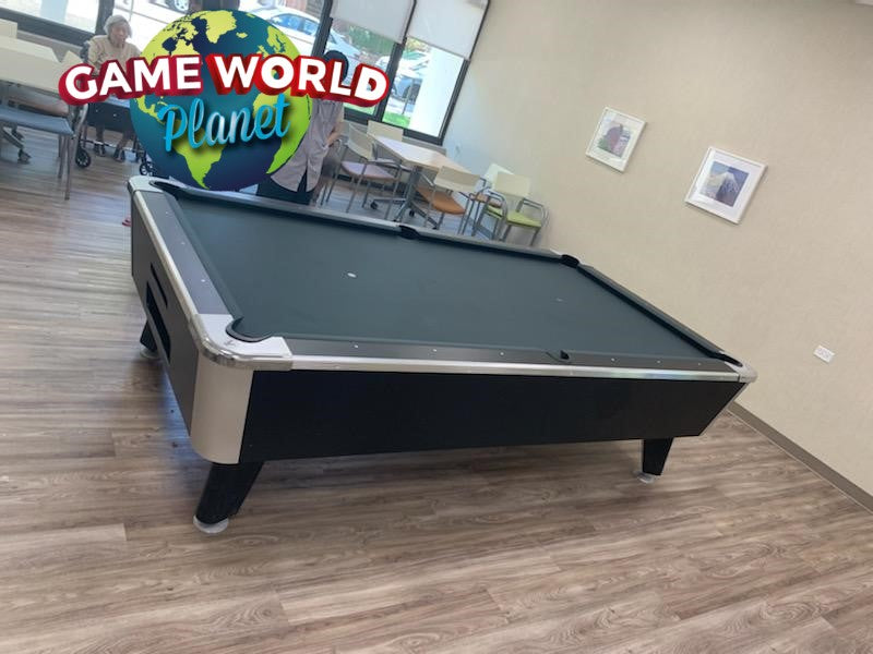 A Great American Legacy Home pool table in a room with chairs, tables, and wall art.