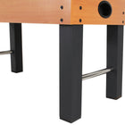 Corner of a DMI Sports American Legend Charger 52" foosball table with black legs and metal bars.