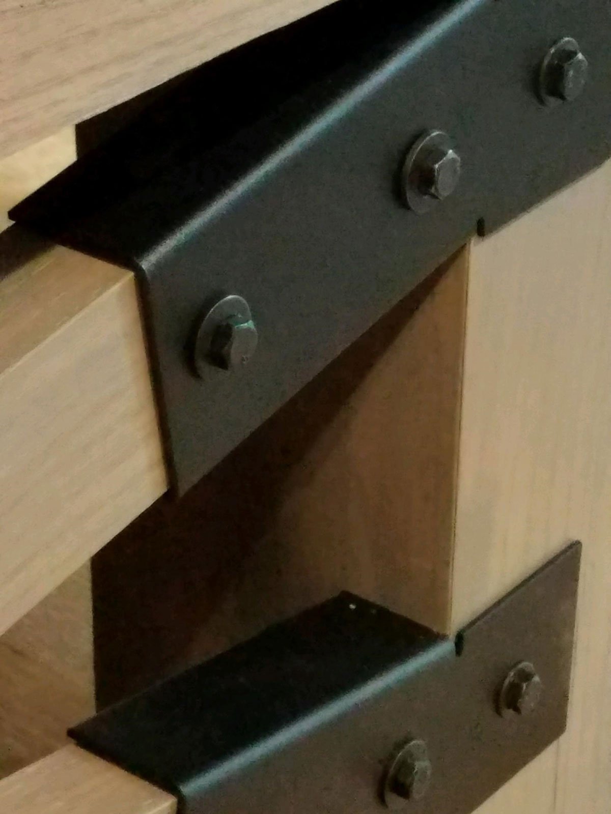 Close-up of metal brackets on the Champion Rustic 9' Shuffleboard Table by Champion.