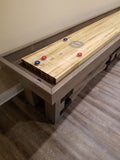 Champion Rustic 9' Shuffleboard Table by Champion with blue and red pucks on maple playfield.
