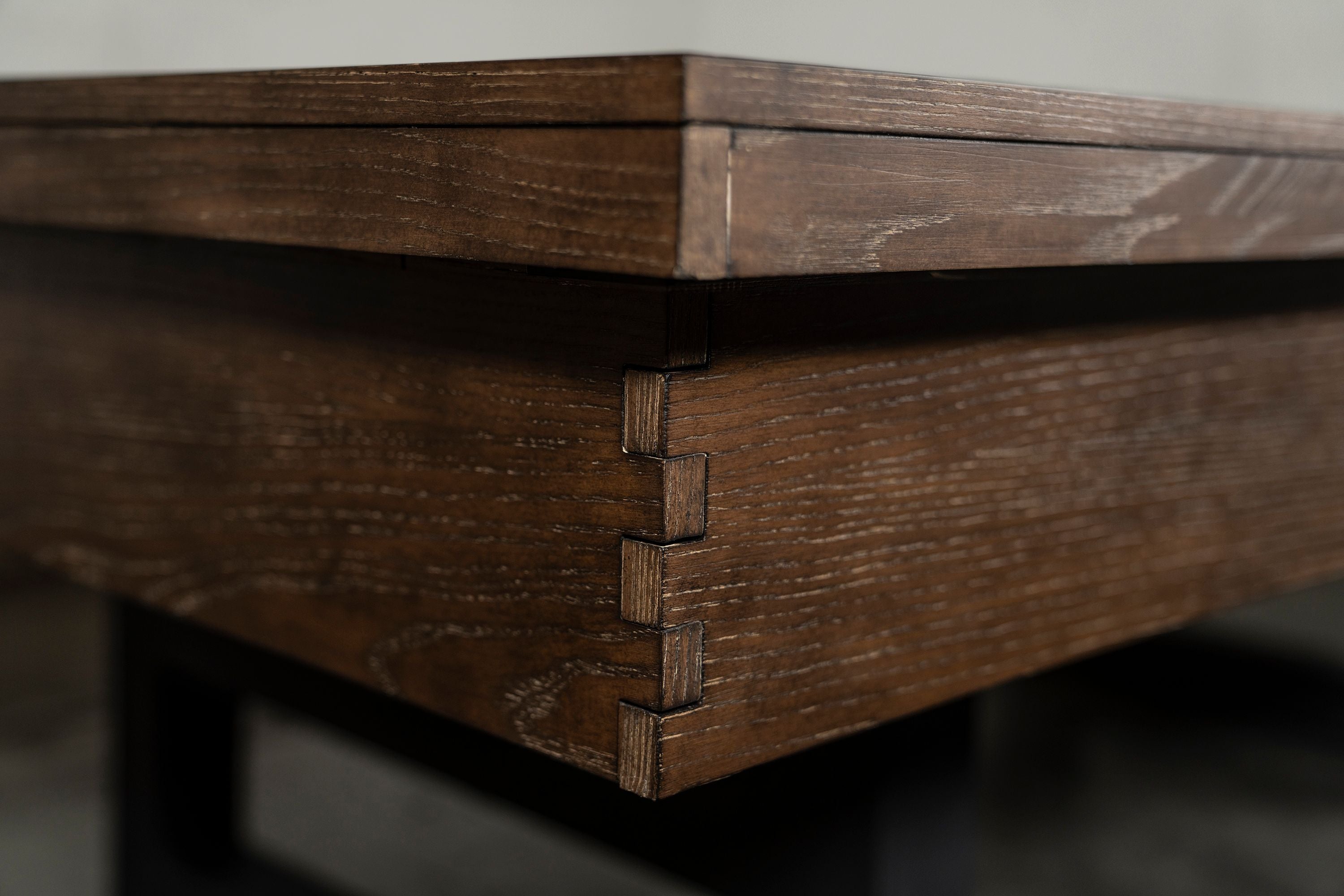 Close-up of Nixon Hunter 7' Slate Pool Table's dovetail joint in Brushed Walnut by Nixon Billiards.