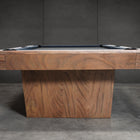 Nixon Billiards KAI 7' Walnut Slate Pool Table with dining top, shown in a dark setting.