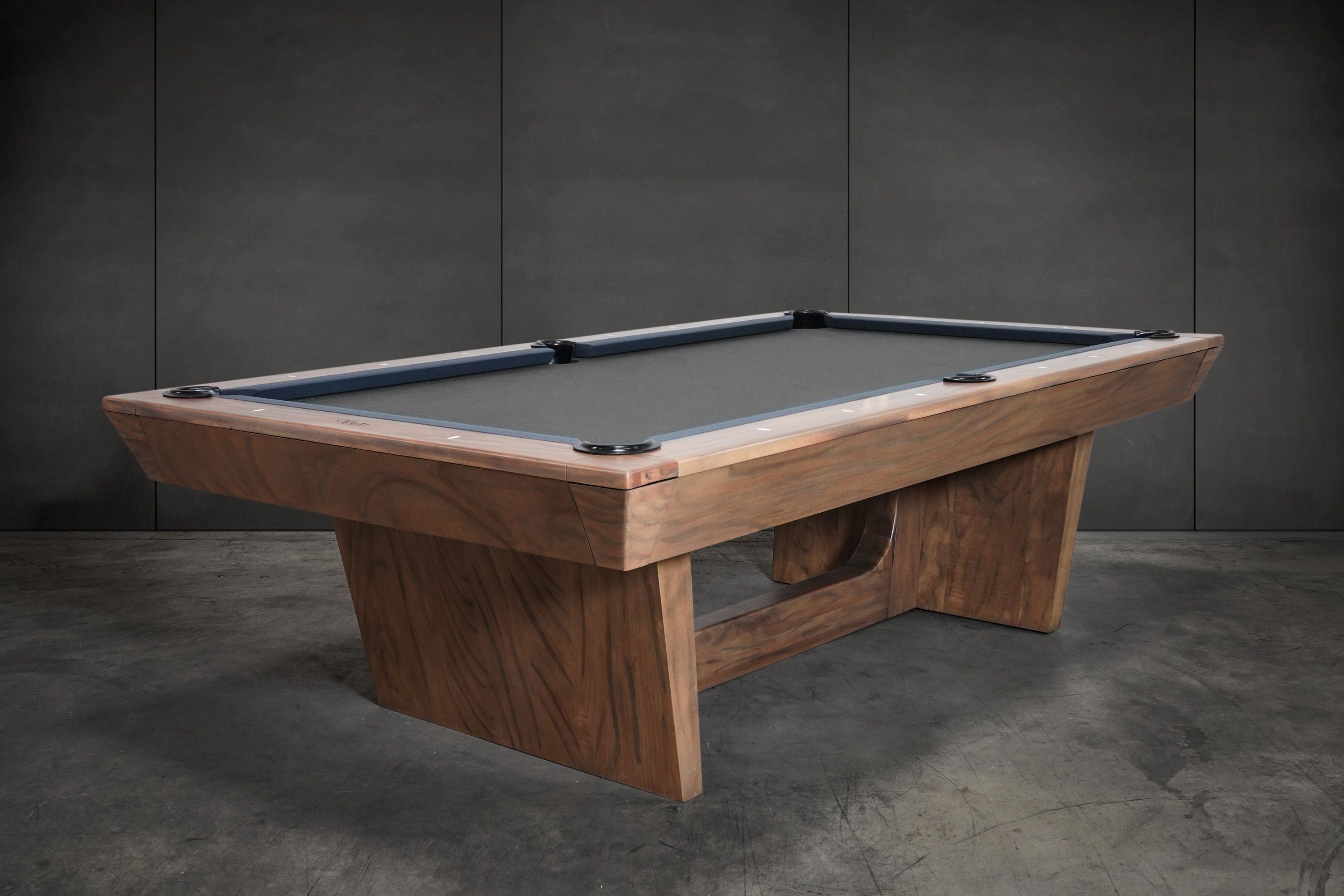 The Nixon KAI 7' Slate Pool Table by Nixon Billiards features a walnut finish and dark felt.
