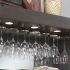 Wine glasses hang below books and decor in the American Heritage Billiards Fairfield Wine Cabinet.