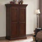 American Heritage Billiards Jordan Wine Cabinet in Navajo beside window and armchair in living room.