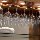 Wine glasses hang above stacked plates in the American Heritage Billiards Braxton Cabinet.