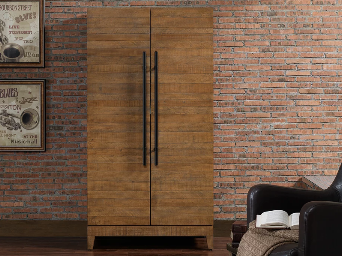 American Heritage Billiards Braxton wine and spirit cabinet with stemware holders, by brick wall.