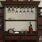 American Heritage Billiards Jordan Wine Cabinet in Navajo with mirrored back and hanging glasses.