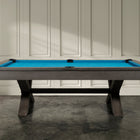 The Nixon CrissyCross 7' Slate Pool Table in charcoal by Nixon Billiards stands on concrete.