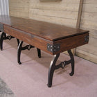 Venture Williamsburg 12' Shuffleboard Table with metal legs on carpet, by a wooden wall.