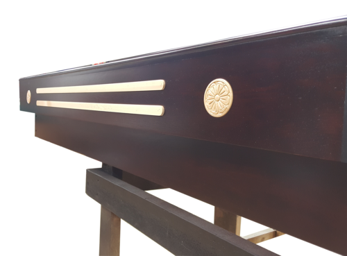 Close-up of the Champion Grand Champion 9' Shuffleboard Table with gold accents and Lifetime Polymer.