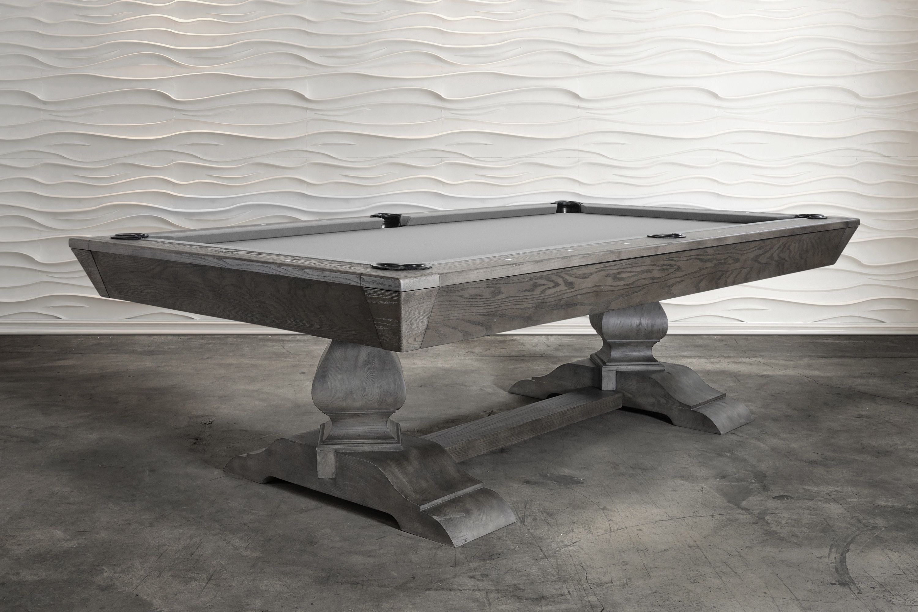 Nixon Birdy 7' Slate Pool Table in Grayson Grey by Nixon Billiards on concrete, wavy white wall.