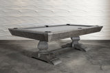 Nixon Birdy 7' Slate Pool Table in Grayson Grey by Nixon Billiards on concrete, wavy white wall.