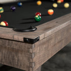 Close-up of a Nixon Hunter 7' Slate Pool Table in Antique Finish with balls on black felt.
