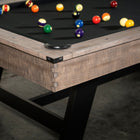 Close-up of Nixon Hunter 7' Slate Pool Table by Nixon Billiards, balls on black felt surface.