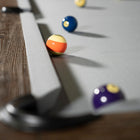 Close-up of billiard balls on a Nixon Billiards Hunter 7' Slate Pool Table in Antique Finish.