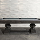 Nixon Birdy 8' Slate Pool Table in Grayson Grey by Nixon Billiards before a wavy white wall.
