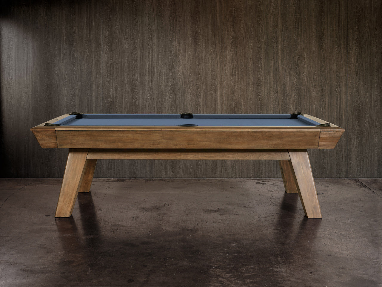 The Nixon Desyn 8' Slate Pool Table by Nixon Billiards features a walnut finish and blue felt.