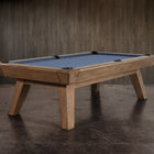 The Nixon Desyn 8' Slate Pool Table by Nixon Billiards features blue felt and walnut finish.