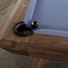 Nixon Billiards Desyn 8' pool table in walnut with blue felt and an 8-ball near the pocket.