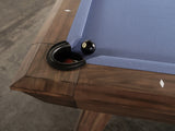 Nixon Billiards Desyn 8' pool table in walnut with blue felt and an 8-ball near the pocket.