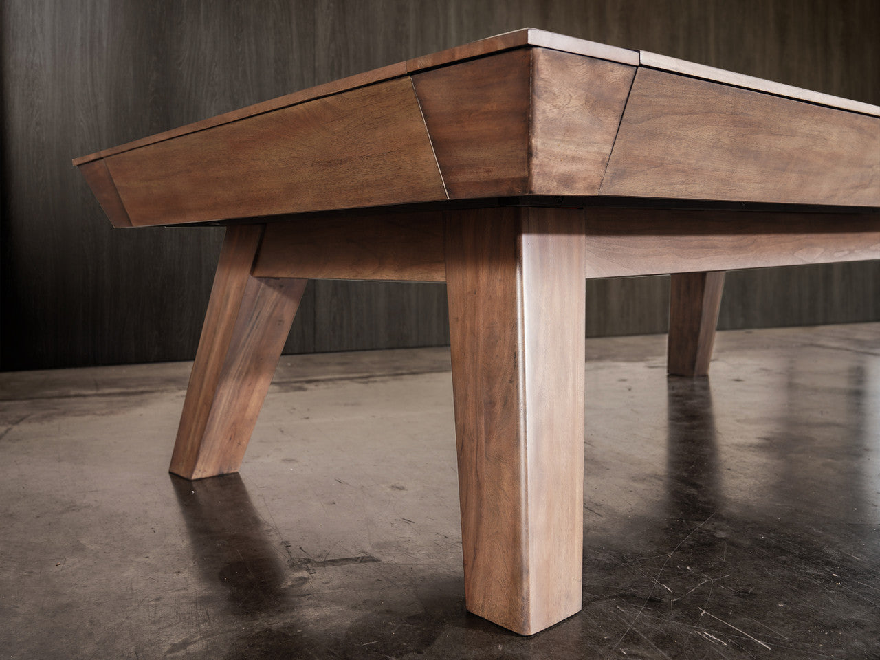 Nixon Billiards Desyn 8' Walnut Pool Table with angled legs on polished concrete floor.