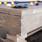 Corner view of Nixon Billiards Huck 7' Slate Pool Table in Grey White Oak with balls on blue felt.