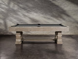 A Nixon Huck 7' Slate Pool Table in Grey White Oak rests on a concrete floor.