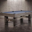 Nixon Billiards Kemp 8' Slate Pool Table in Grayson Grey with blue felt in concrete room.