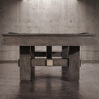 The Nixon Kemp 8' Slate Pool Table by Nixon Billiards adds charm to the modern concrete room.