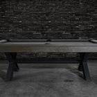 The Nixon Portland 8' Barnwood Pool Table by Nixon Billiards stands before a dark brick wall.