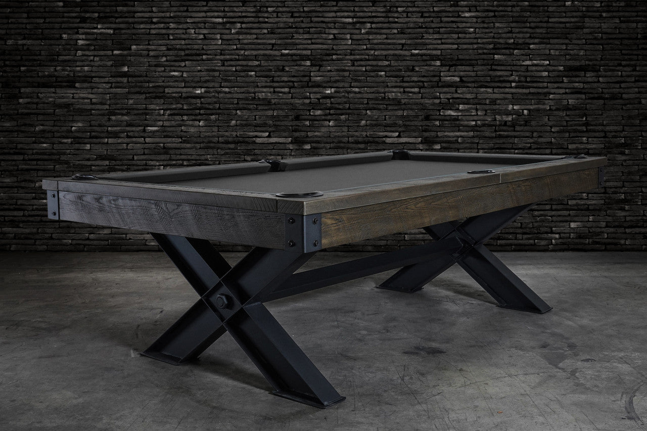 Nixon Billiards Portland 8' Barnwood Pool Table with black legs, set by a brick wall.