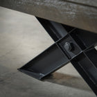 Close-up of a black X-leg from the Nixon Portland 8' Barnwood Pool Table by Nixon Billiards.