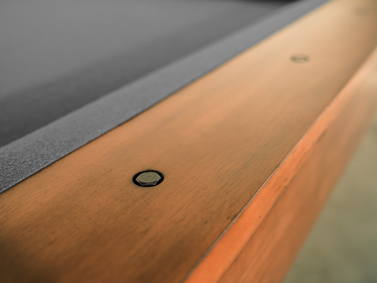 Close-up of Nixon Presli 8' pool table edge in Native Acacia finish by Nixon Billiards.