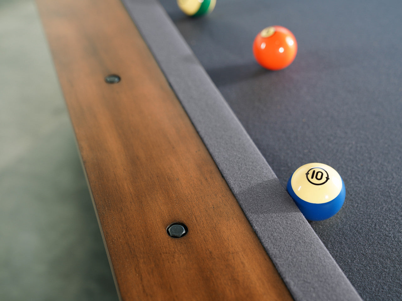 Nixon Presli 8' Slate Pool Table by Nixon Billiards in Native Acacia, balls near table edge.