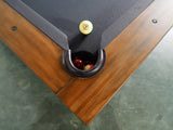 A 14 ball sits by the pocket of a Nixon Presli 7' Slate Pool Table in Native Acacia finish.
