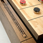 Brunswick Billiards Parsons 12' Shuffleboard Table with red/black pucks and wooden scoring track.