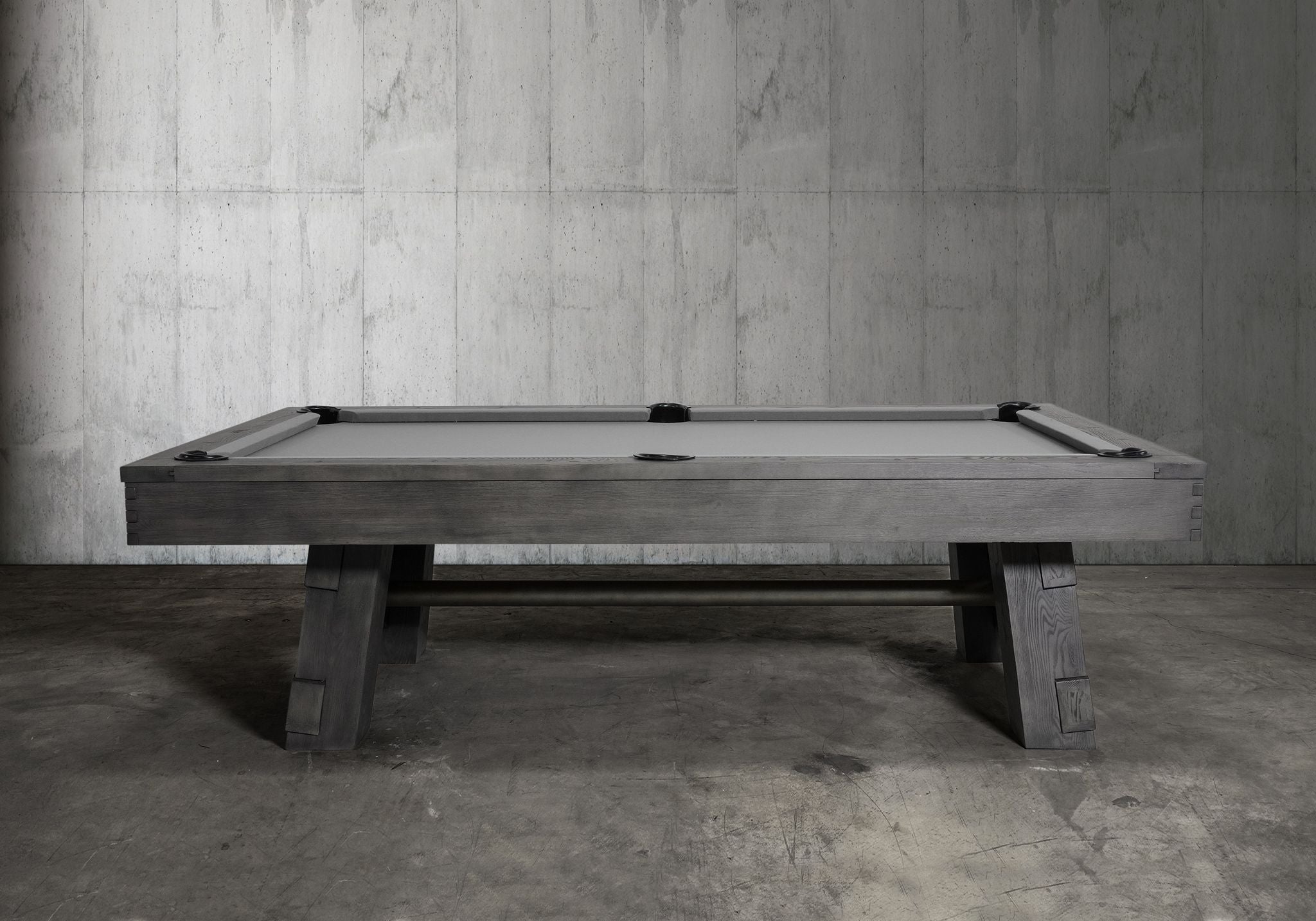 Nixon Georgia 7' Slate Pool Table in Grayson Grey by Nixon Billiards sits in a concrete room.
