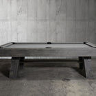 Nixon Georgia 7' Slate Pool Table in Grayson Grey by Nixon Billiards sits in a concrete room.