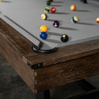 Close-up of Nixon Billiards Hunter 7' Slate Pool Table in Brushed Walnut with balls on grey felt.